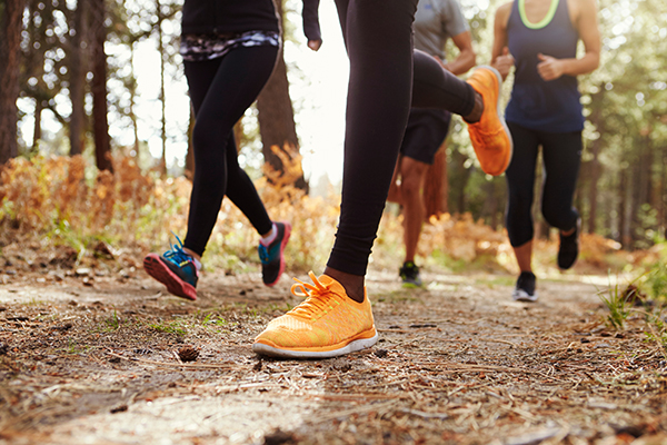 Shot of runners on a trail. Running is a common exercise for active individuals but can cause ankle and knee injuries for some. If that's you, Dr. Goradia of G2 Orthopedics is here to help you get up and running again in no time.